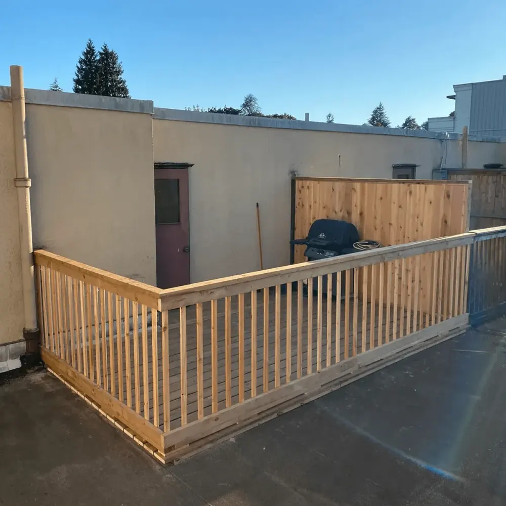 New cedar deck railing and cedar privacy screen on a rooftop patio